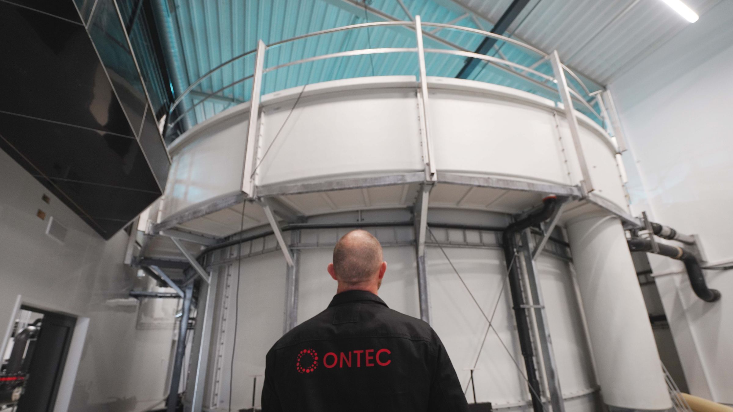 An Ontec technician in front of a RAS tank
